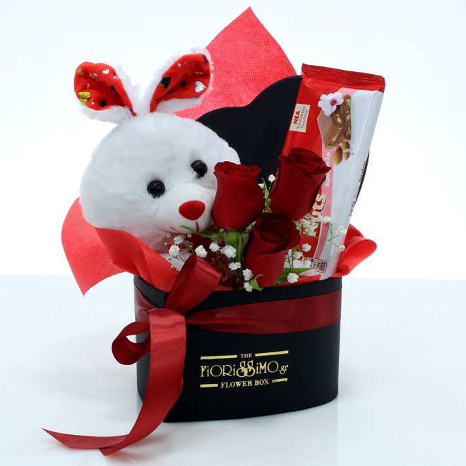 Heart shape box with red roses, bunny and chocolate