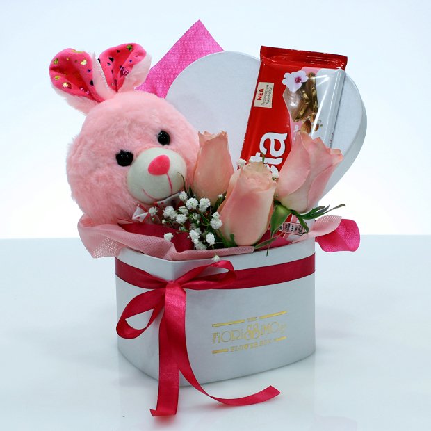 Heart shape box with pink roses, bunny and chocolate